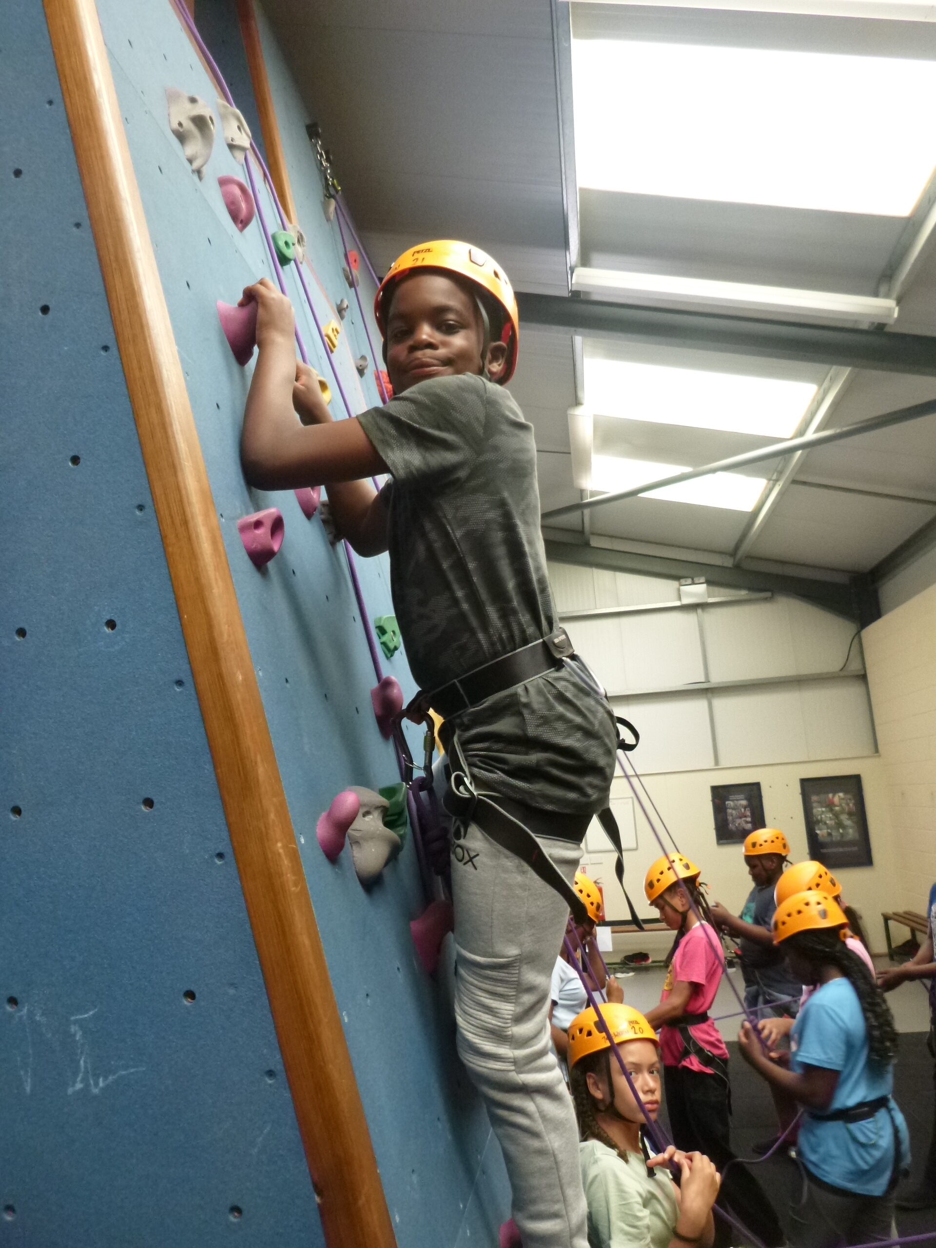 A climber on the climbing wall at Trewern